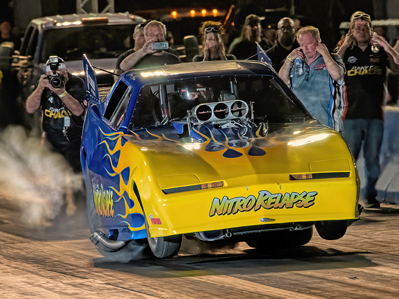 A nitro Funny Car speeds down the dragstrip during a Funny Car Chaos event.