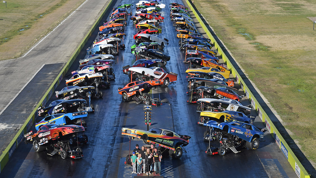 The Graves family stands in front of the Funny Car lineup for a Funny Car Chaos event.