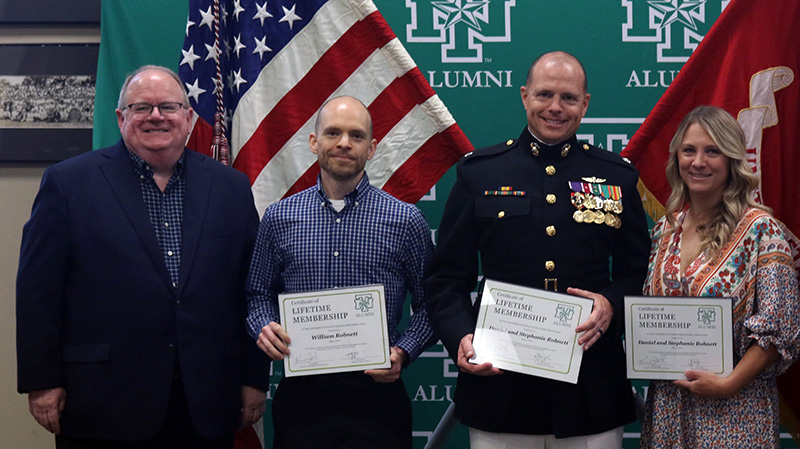 From L-R: Mike Robnett, William Robnett, Daniel Robnett and his wife, Stephanie, at Daniel's promotion ceremony at the UNT Alumni Association in 2022.