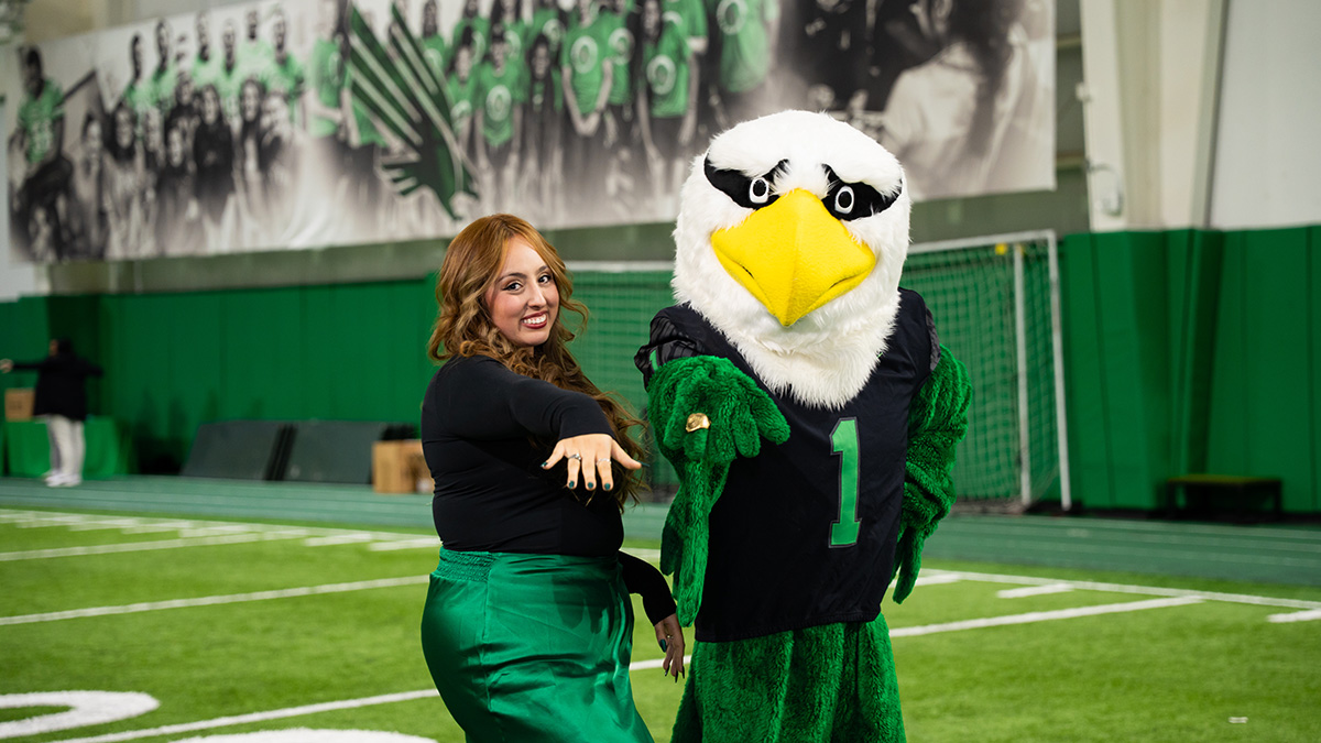 Juliette Rivera and Scrappy pose with their UNT Rings.